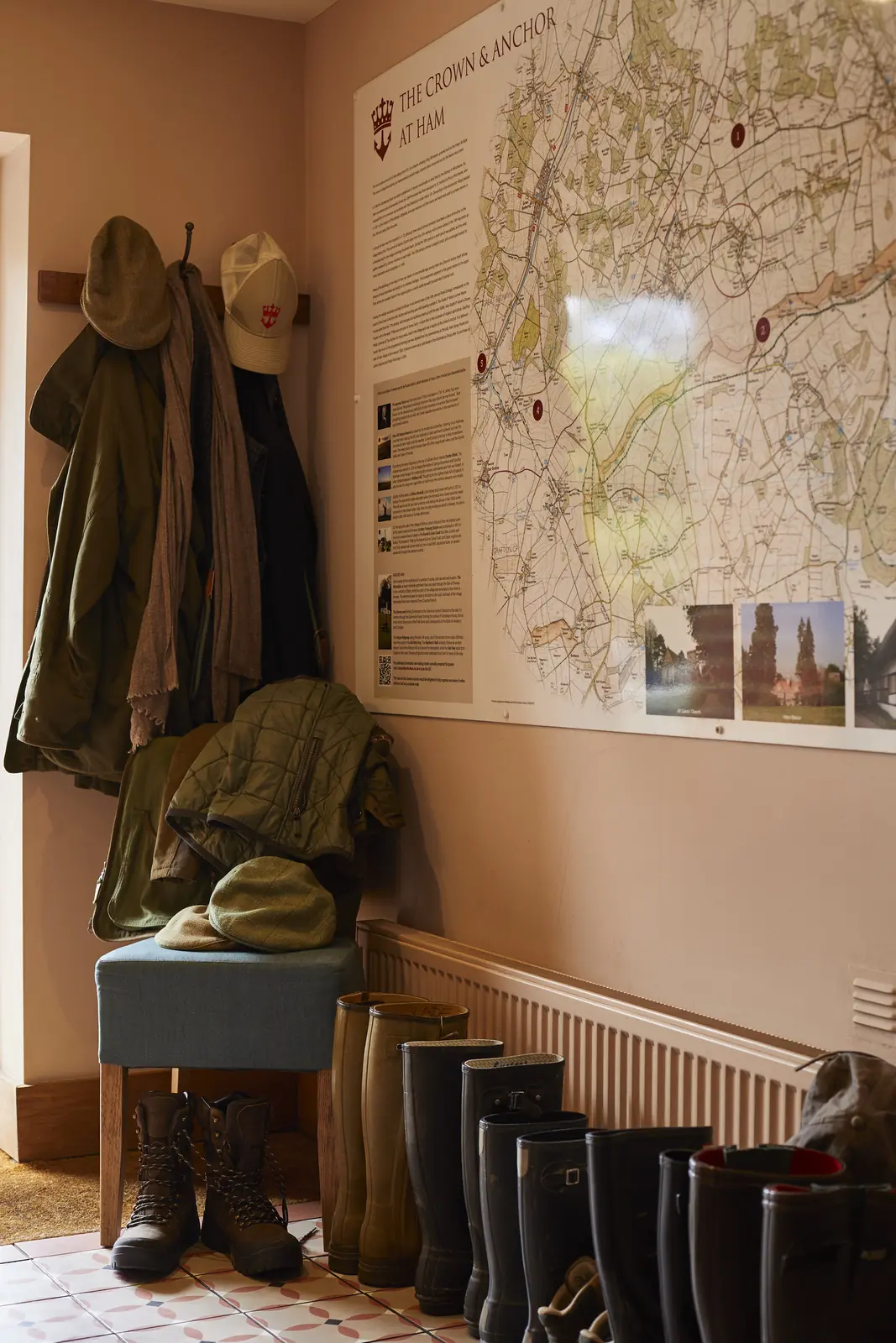 Walking boots and wax jackets by the door, under a map of local walks