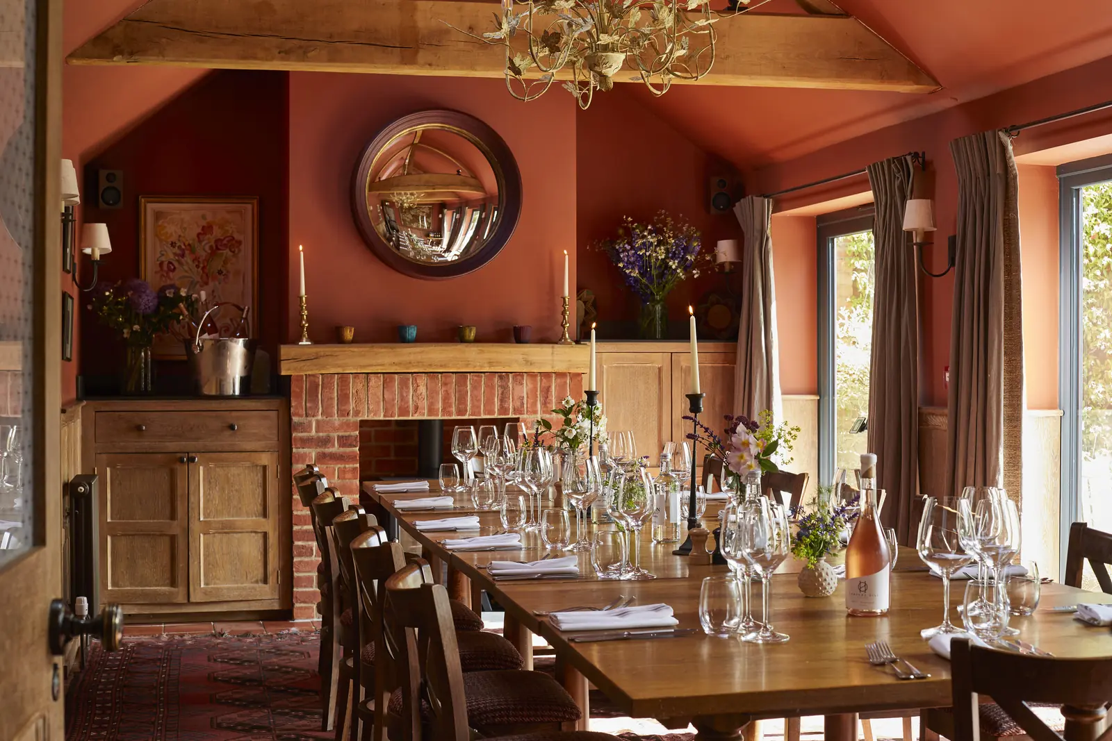 The Partridge Room laid for a private dinner, with terracotta walls and a round mirror