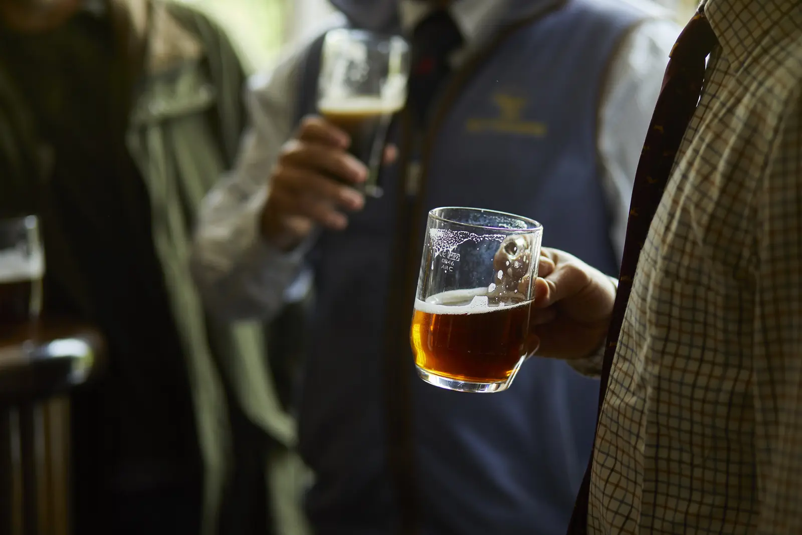 A pint of bitter raised at the bar