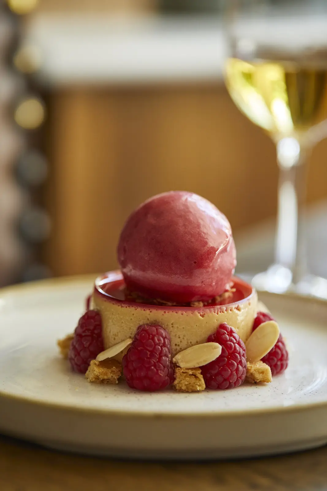 Raspberry sorbet on a set cream with almonds