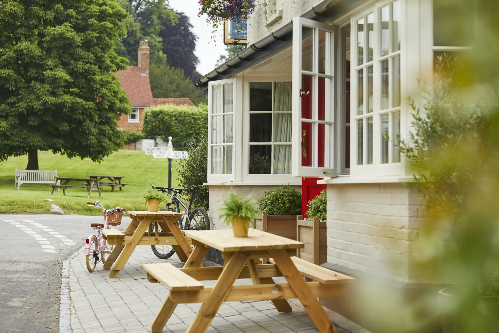 Picnic benches on the terrace looking over the village green
