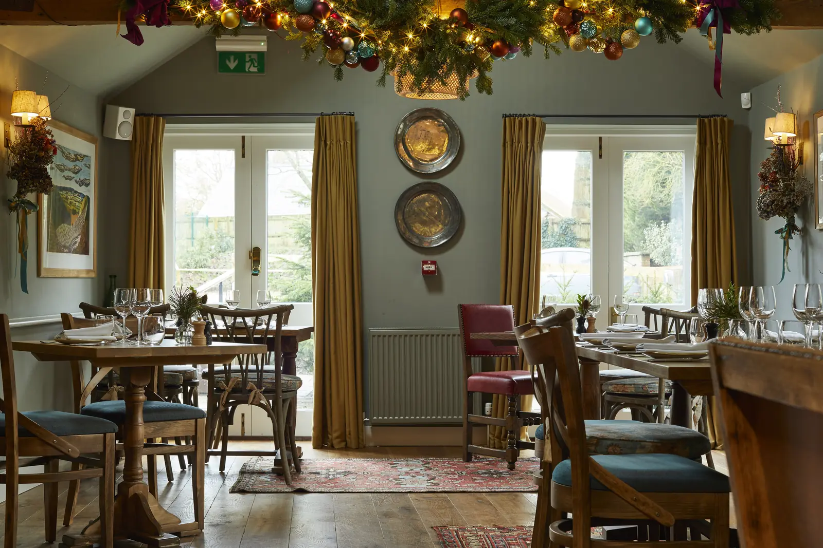 The dining room dressed for Christmas with garlands and lights